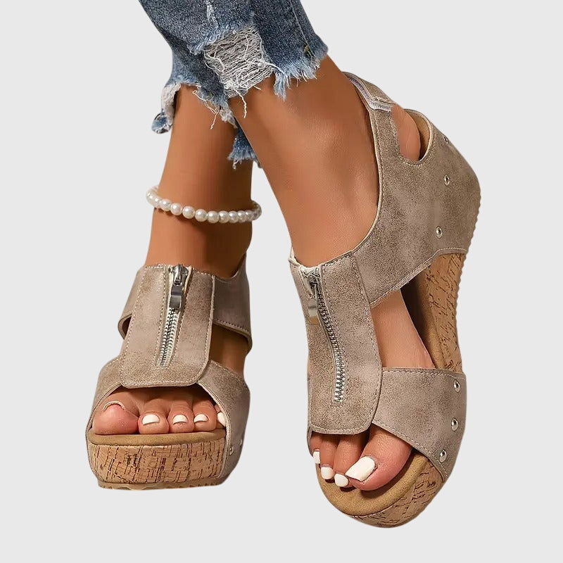 Black Styla™ orthopedic sandals by THE WHITMORE FAMILY with cushioned straps and supportive soles for comfortable wear.