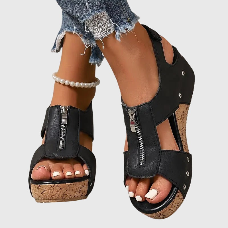 Black Styla™ orthopedic sandals by THE WHITMORE FAMILY featuring cushioned straps and supportive soles for comfort.