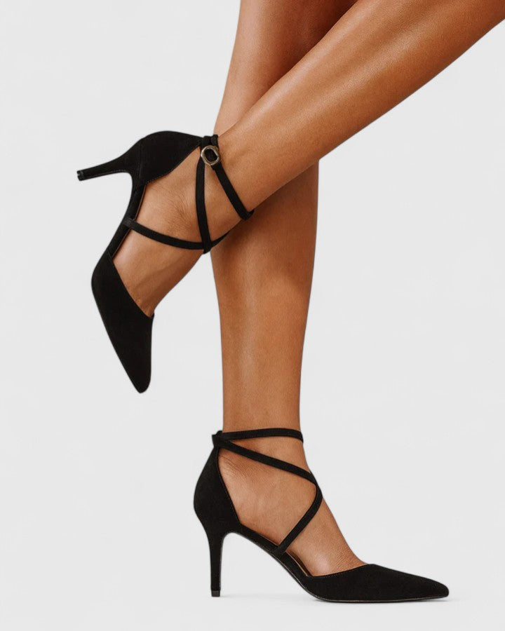 Black Veylah elegant heels by THE WHITMORE FAMILY with pointed toes and sleek design, perfect for formal occasions.