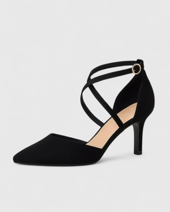 Black Veylah elegant heels from THE WHITMORE FAMILY featuring a sleek design and pointed toe on a neutral background.
