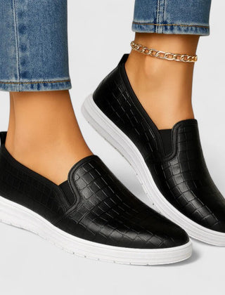 Black Zhielle Supportive Style Loafers by THE WHITMORE FAMILY, shown from a side angle on a white background.