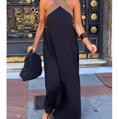 Black Delphine dress with crossed cut detail by THE WHITMORE FAMILY, shown in XS size on a model.
