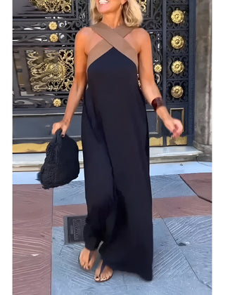 Black Delphine dress with crossed cut detail by THE WHITMORE FAMILY, shown in XS size on a model.