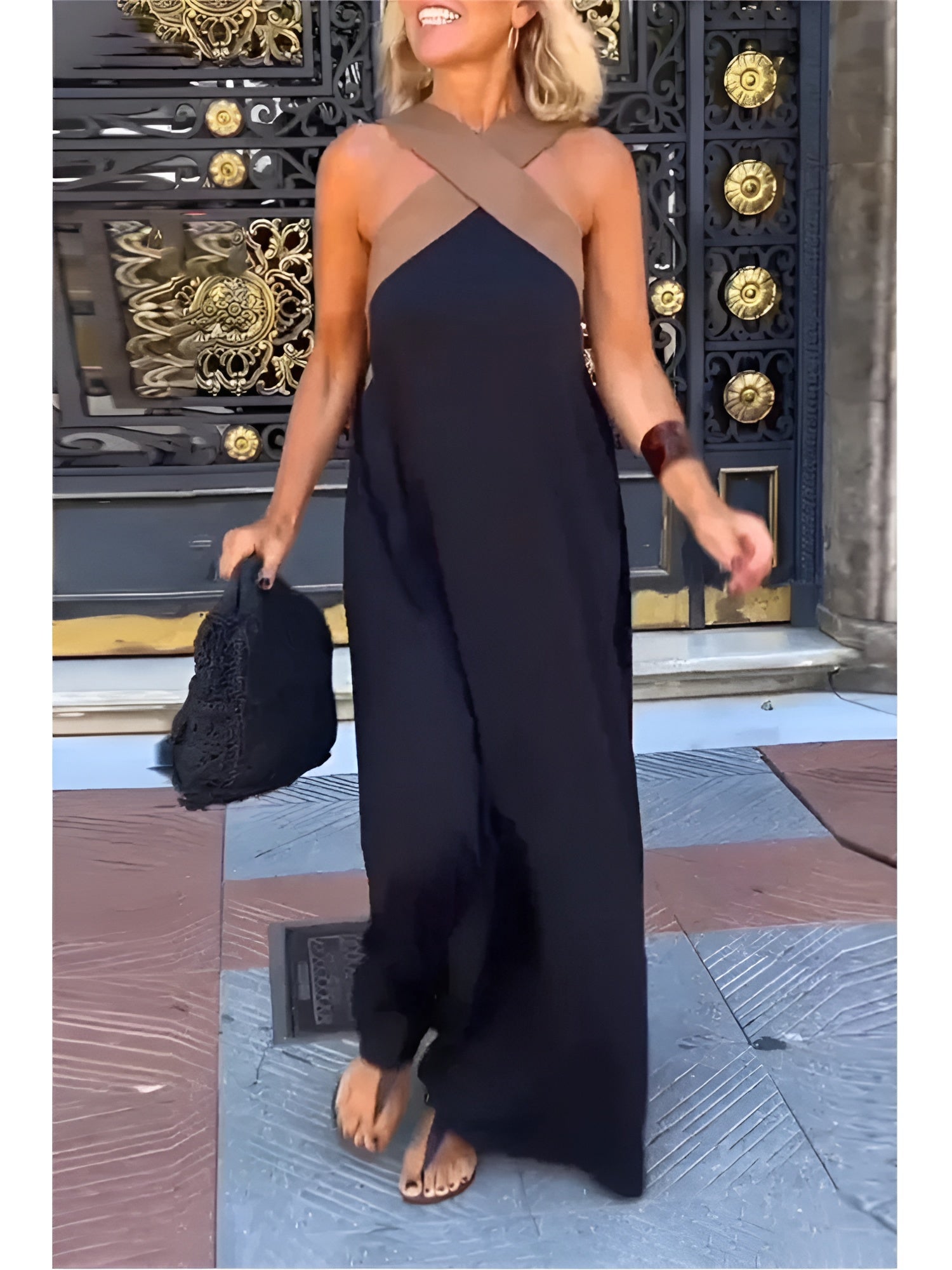 Black Delphine dress with crossed cut detail by THE WHITMORE FAMILY, shown in XS size on a model.