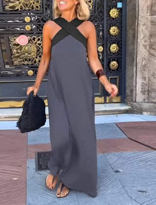 Black Delphine dress with crossed cut detail from THE WHITMORE FAMILY, shown in XS size on a model.
