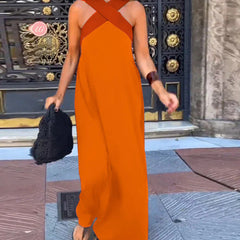 Black Delphine dress with crossed cut detail from THE WHITMORE FAMILY, shown on a model, featuring a stylish, fitted silhouette.