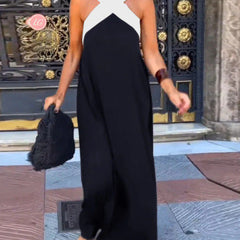 Black Delphine dress with crossed cut detail from THE WHITMORE FAMILY, shown on a model, in size XS.