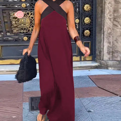 Black Delphine dress with crossed cut detail by THE WHITMORE FAMILY, shown in size XS on a model.