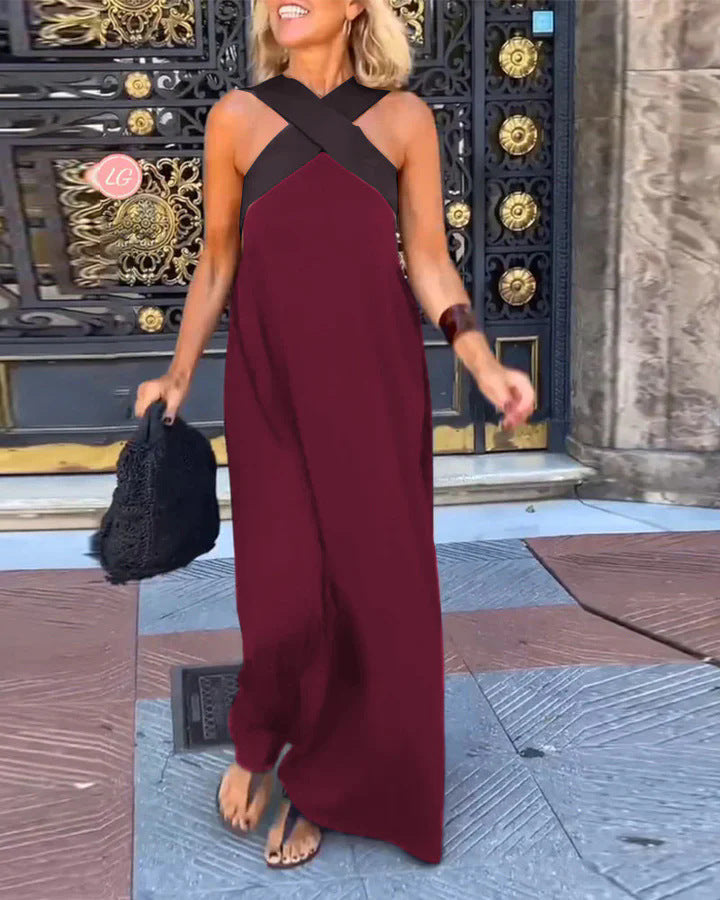 Black Delphine dress with crossed cut detail by THE WHITMORE FAMILY, shown in size XS on a model.