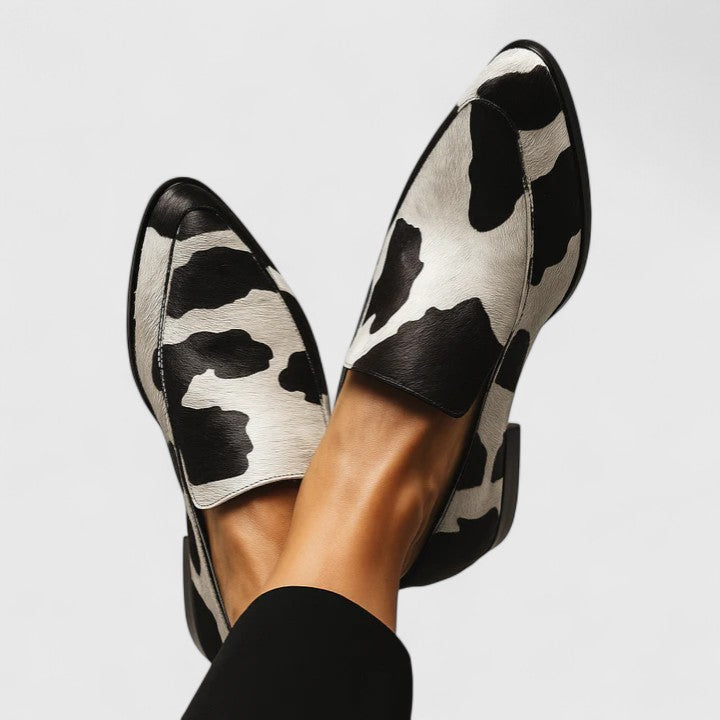 Black Quinzee Cushioned Elegance Loafers by THE WHITMORE FAMILY, showcasing sleek design and comfortable padded insoles.