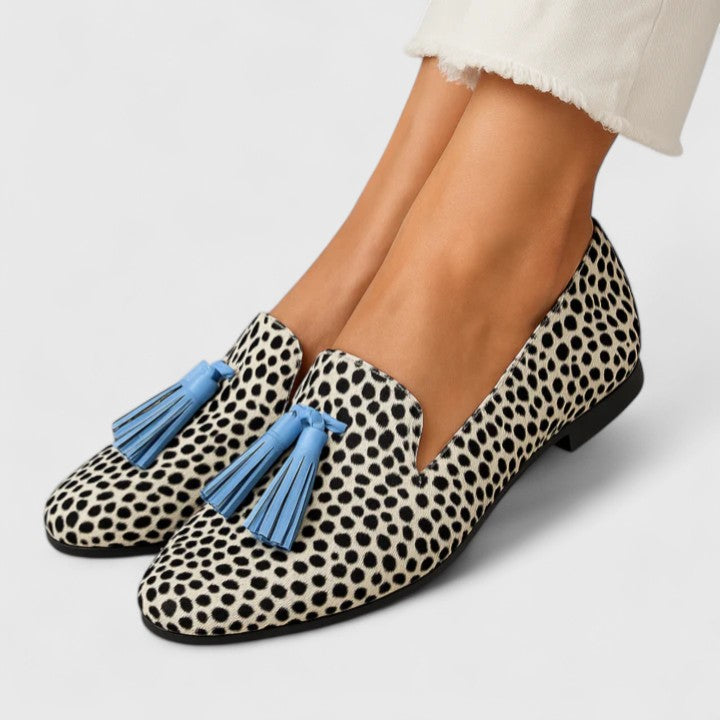 Black and white Yzabella Refined Comfort Loafers by THE WHITMORE FAMILY, showcasing stylish slip-on footwear with a sleek design.