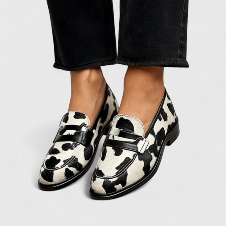 Black and white Zhaylin comfortable loafers by THE WHITMORE FAMILY, featuring a classic slip-on design and soft leather material.