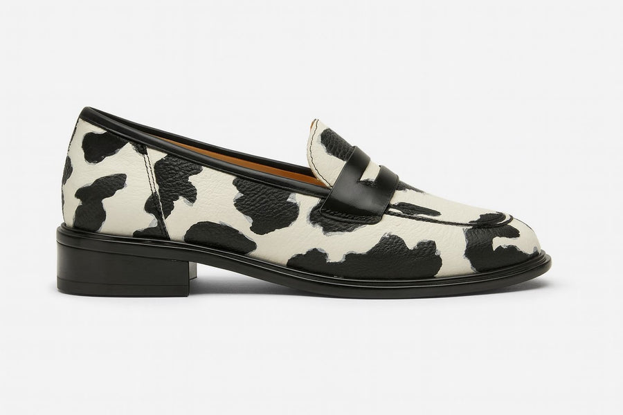 Black and white Zhaylin comfortable loafers by THE WHITMORE FAMILY, featuring a sleek slip-on design and cushioned interior.