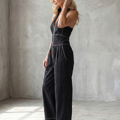 Black Dara zip-front wide-leg jumpsuit with contrast stitching from THE WHITMORE FAMILY, featuring a stylish and comfortable design.