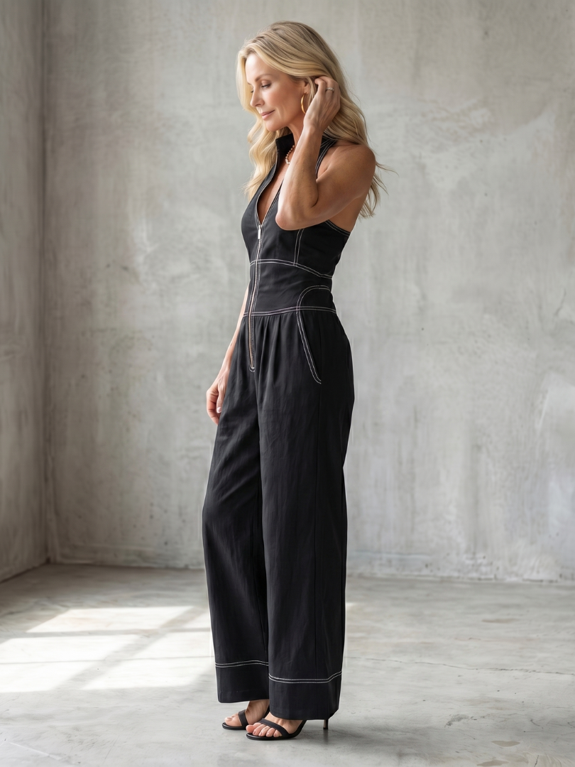Black Dara zip-front wide-leg jumpsuit with contrast stitching from THE WHITMORE FAMILY, featuring a stylish and comfortable design.