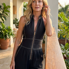 Black Dara jumpsuit by THE WHITMORE FAMILY with zip front, contrast stitching, wide-leg design, and long sleeves.