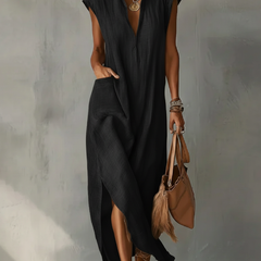 Black Elara ruffle spring maxi dress by THE WHITMORE FAMILY, flowing fabric with ruffle details and a stylish silhouette.