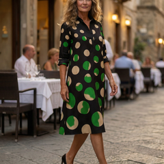 Black Kaia Dinner Walk Dress by THE WHITMORE FAMILY, showcasing a stylish, elegant dress with a flowy silhouette and intricate detailing.