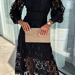 Black Liza romantic lace dress by THE WHITMORE FAMILY, featuring delicate lace details and a flattering silhouette.
