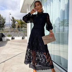 Black Liza romantic lace dress by THE WHITMORE FAMILY, featuring delicate lace fabric and elegant design.