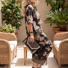 Black Mina printed wide-leg wrap top set by THE WHITMORE FAMILY, featuring a stylish wrap top and matching wide-leg pants.