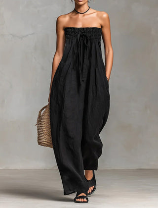 Black Nova strapless flow maxi dress by THE WHITMORE FAMILY, flowing fabric and elegant design perfect for formal occasions.