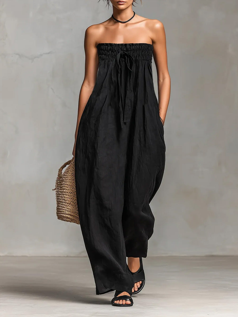 Black Nova strapless flow maxi dress by THE WHITMORE FAMILY, flowing fabric and elegant design perfect for formal occasions.