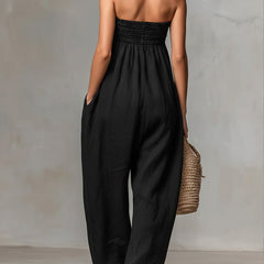 Black Nova strapless flow maxi dress by THE WHITMORE FAMILY, featuring a flowing fabric and elegant strapless design.