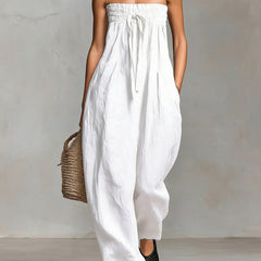 Black Nova strapless flow maxi dress by THE WHITMORE FAMILY, featuring a flowing design and elegant strapless silhouette.