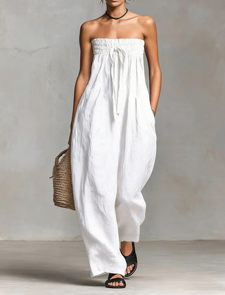 Black Nova strapless flow maxi dress by THE WHITMORE FAMILY, featuring a flowing design and elegant strapless silhouette.