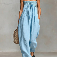 Black Nova strapless flow maxi dress by THE WHITMORE FAMILY, featuring a long, flowing silhouette and elegant neckline.