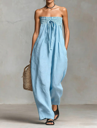 Black Nova strapless flow maxi dress by THE WHITMORE FAMILY, featuring a long, flowing silhouette and elegant neckline.