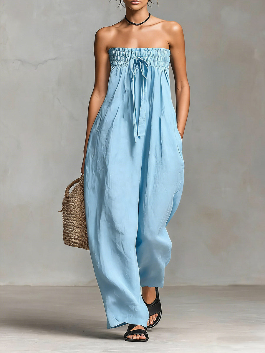 Black Nova strapless flow maxi dress by THE WHITMORE FAMILY, featuring a long, flowing silhouette and elegant neckline.