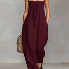 Black Nova strapless flow maxi dress by THE WHITMORE FAMILY, flowing fabric with a fitted bodice and elegant design.