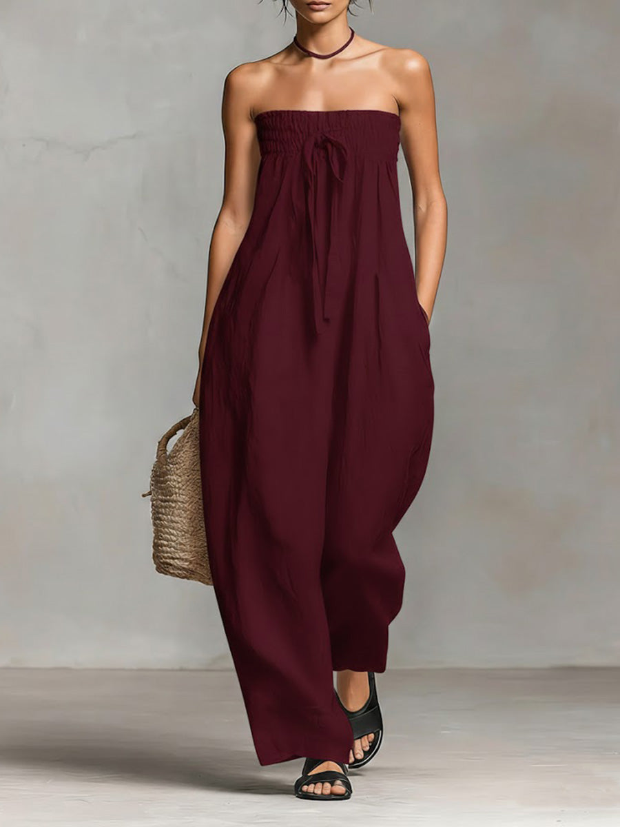 Black Nova strapless flow maxi dress by THE WHITMORE FAMILY, flowing fabric with a fitted bodice and elegant design.
