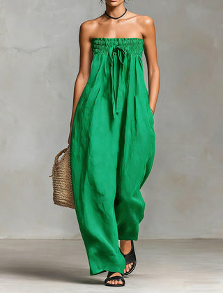Black Nova strapless flow maxi dress by THE WHITMORE FAMILY, featuring a flowing fabric and elegant strapless design.