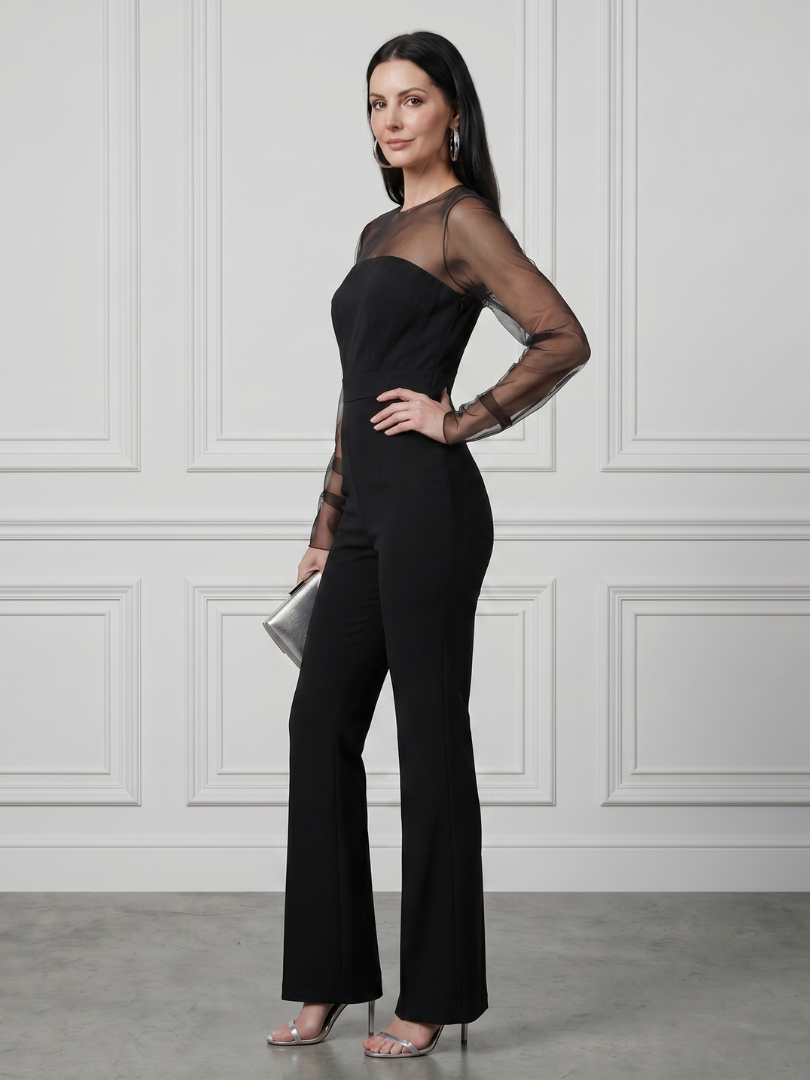Black Oksana sheer fitted bodice flared leg jumpsuit by THE WHITMORE FAMILY, featuring a sleek silhouette and elegant design.