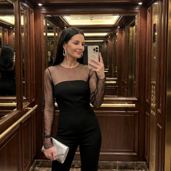 Black Oksana jumpsuit by THE WHITMORE FAMILY featuring a sheer fitted bodice and flared leg design.