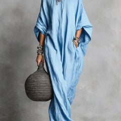 Black Serena oversized maxi dress by THE WHITMORE FAMILY with flowing fabric and relaxed fit, shown on a model.