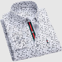 Valentino™ Floral Essence Shirt by THE WHITMORE FAMILY featuring a vibrant floral print and classic collar, displayed on a hanger.