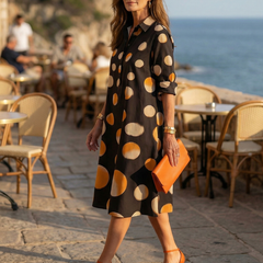 Black Vespera Sunset Dot Dress by THE WHITMORE FAMILY, featuring a flowy silhouette with sunset-inspired dot pattern.