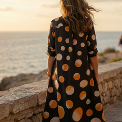 Black Vespera Sunset Dot Dress by THE WHITMORE FAMILY featuring a stylish sunset dot pattern on lightweight fabric.