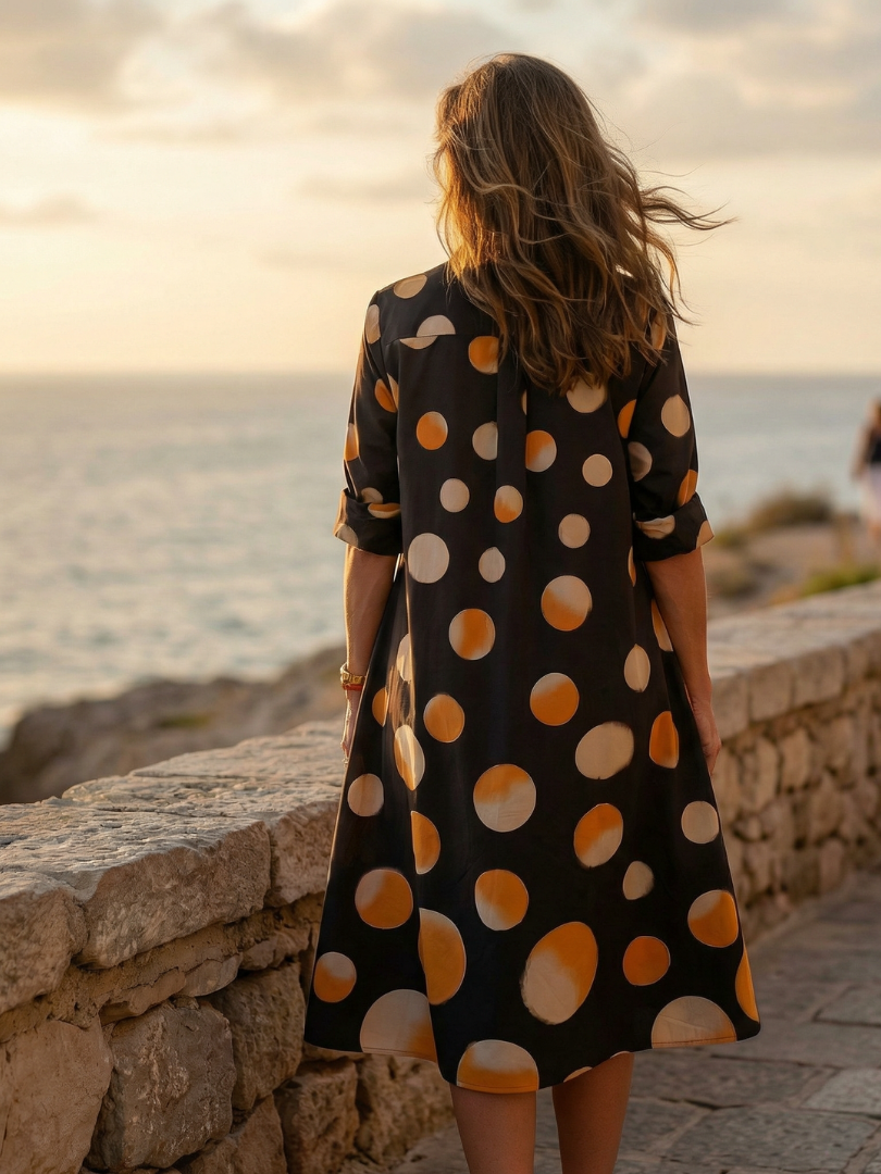 Black Vespera Sunset Dot Dress by THE WHITMORE FAMILY featuring a stylish sunset dot pattern on lightweight fabric.