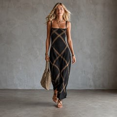 Black Amelia geometric print maxi dress by THE WHITMORE FAMILY, flowing fabric with bold pattern and elegant silhouette.