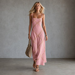 Black Amelia geometric print maxi dress by THE WHITMORE FAMILY, flowing fabric, sleeveless design, and bold pattern.