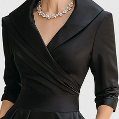 Black Zyrah™ elegant midi dress by THE WHITMORE FAMILY, shown on a model with a fitted bodice and flowing skirt.