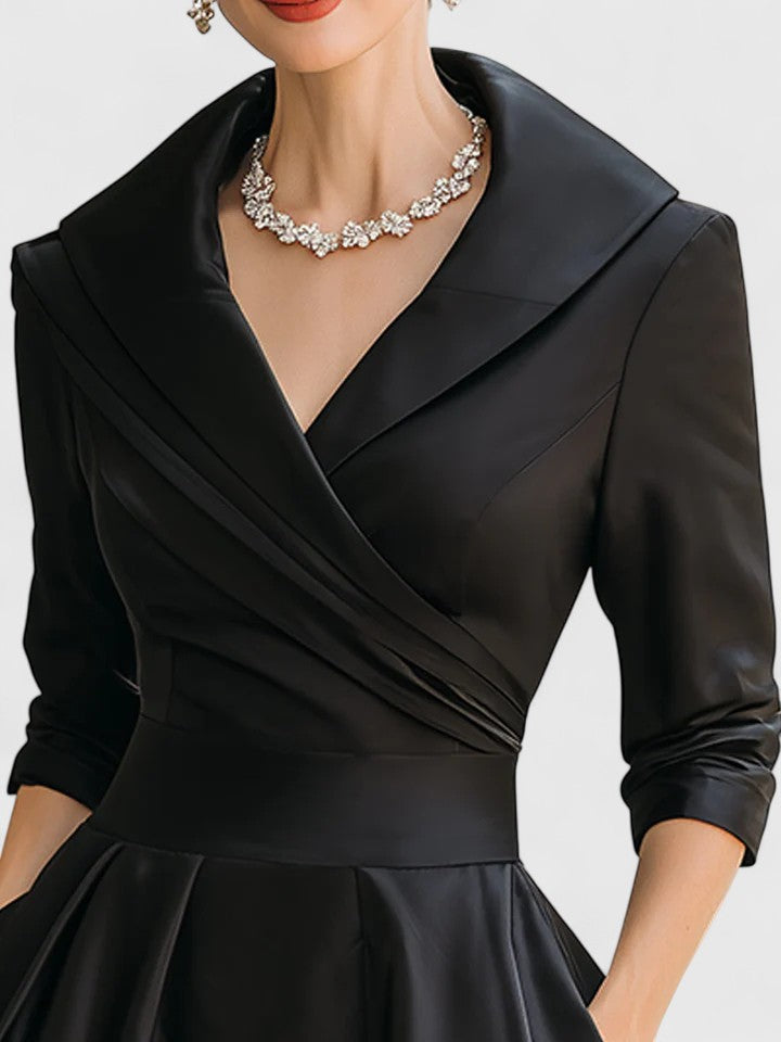 Black Zyrah™ elegant midi dress by THE WHITMORE FAMILY, shown on a model with a fitted bodice and flowing skirt.