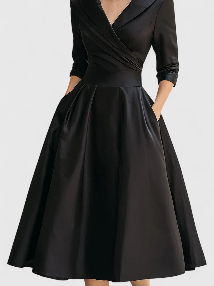 Black Zyrah™ Elegant Midi Dress by THE WHITMORE FAMILY, featuring a fitted silhouette and stylish design for formal occasions.