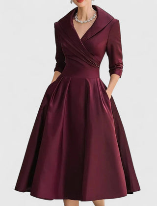 Black Zyrah™ elegant midi dress from THE WHITMORE FAMILY, showcasing a fitted silhouette and stylish design.