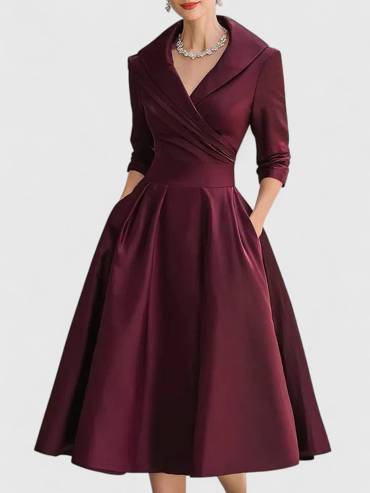 Black Zyrah™ elegant midi dress from THE WHITMORE FAMILY, showcasing a fitted silhouette and stylish design.